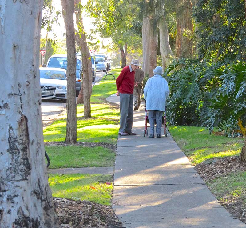 Elderly people talking on a street